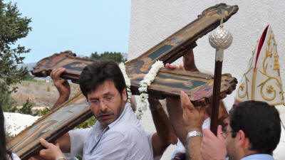 The 15th century cross is prepared for its parade round the village